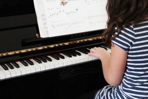 little girl playing the piano